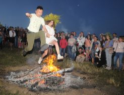 Young people jump over the fire