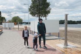 Woman with children walks on the beach