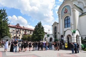 Men bring a coffin to the Holy Virgin Cathedral