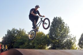 Teenager on a bike jumps from a springboard