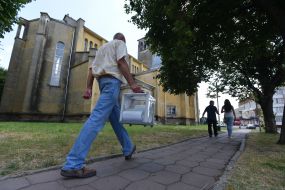 Представители избирательного участка с переносной урной для голосования