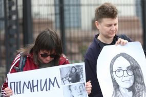 Participants of the action with poster and portrait of Elena Grigorieva near the Russian Embassy