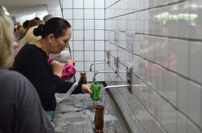 People pump water in a mineral water pump room in Truskavets