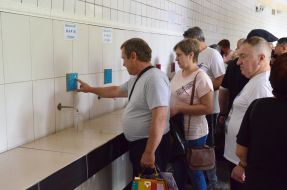 People pump water in a mineral water pump room in Truskavets