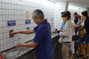 People pump water in a mineral water pump room in Truskavets