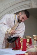Priest prepares God's Gifts for Communion
