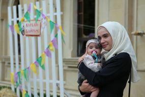Muslim woman with baby in her arms
