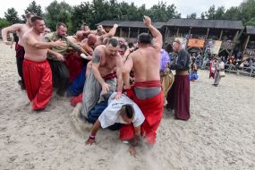 Men in the national Ukrainian costumes, demonstrate techniques of unarmed combat