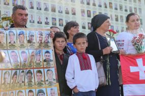 People with flowers near the memorial Wall