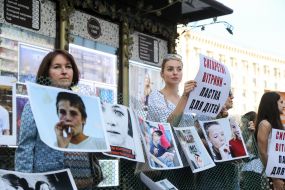 The protesters with placards near the tobacco kiosk