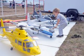The boy looks at the aircraft model