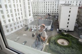 Worker in a construction cradle outside the window of the Cabinet of Ministers of Ukraine