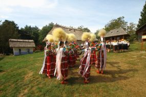 Girls in high hats of feather grass