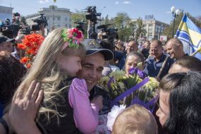 Victor Bespalchenko holds a baby girl in her arms