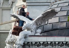 Experts examine the front of the House with chimeras