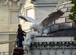 Experts examine the front of the House with chimeras