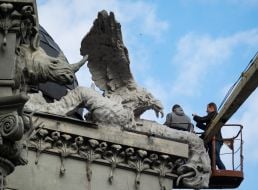 Experts examine the front of the House with chimeras