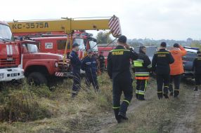 Rescuers are working on the site of the An-12 transport plane crash