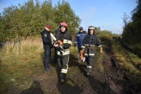 Rescuers are working on the site of the An-12 transport plane crash