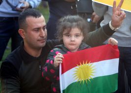 Girl holding the flag of Kurdistan