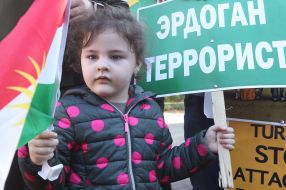 Girl holding the flag of Kurdistan