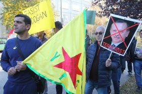 Representatives of the Kurdish Diaspora with crossed profile of Turkish President Recep Erdog and Kurdistan flag