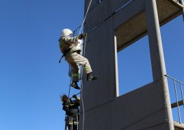 Firefighters work off the action at altitude