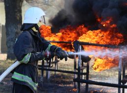 The fireman extinguishes the flames