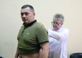 The doctor examines Mykola Povoroznyk before vaccination