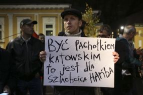 The activist holds a poster with the inscription in Polish