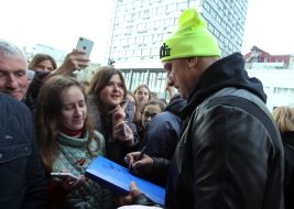 Potap (Alexei Potapenko) gives an autograph to a fan