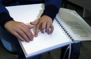 Specialized boarding school # 5 for visually impaired children read books in Braille