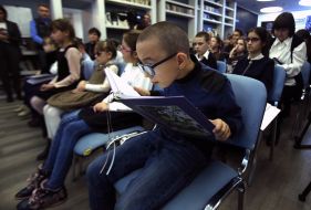 Specialized boarding school # 5 for visually impaired children holds a book in Braille