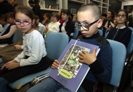 Specialized boarding school # 5 for visually impaired children holds a book in Braille