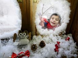 The boy looks out the window panes at St. Nicholas' Residence