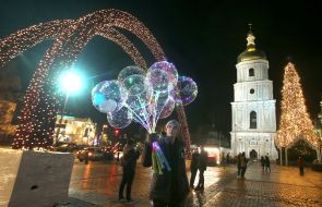 A man carries balloons
