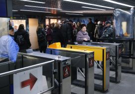 A woman goes through a turnstile