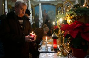 People light candles and oil lamps
