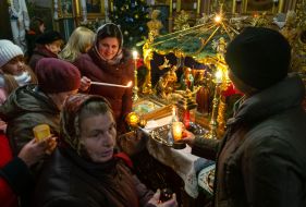 People light candles and oil lamps