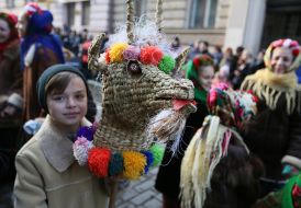 Boy with a straw goat wheel on a stick