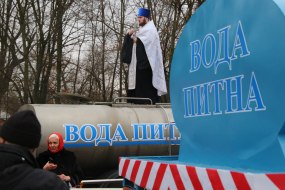 The priest consecrates a drinking water tank