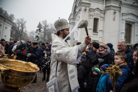 The priest sprinkles the believers with holy water