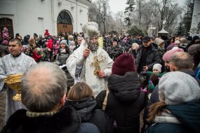 The priest sprinkles the believers with holy water