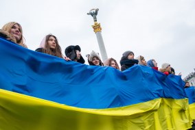 Pupils hold the flag of Ukraine