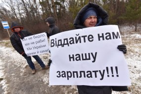 A woman holds a poster