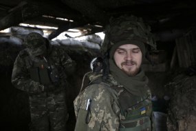 Ukrainian serviceman with a rat on his shoulder