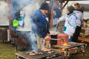 Participants of the XIVth Festival of Differences prepare meat dishes on the grill