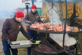 Participants of the XIVth Festival of Differences prepare meat dishes on the grill