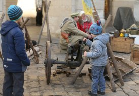 The boys are looking at the gun