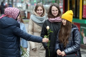 Учасниця акції дарує квіти